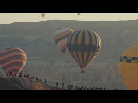 A hot air balloon flying over the desert hills & mountains |Video-Audio footage HD Free