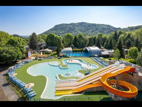 Swimming pool and waterslides in the water park at the La Ribeyre campsite