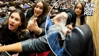 Tense moment Argentine Deputy gets water thrown at her during altercation over crypto scandal